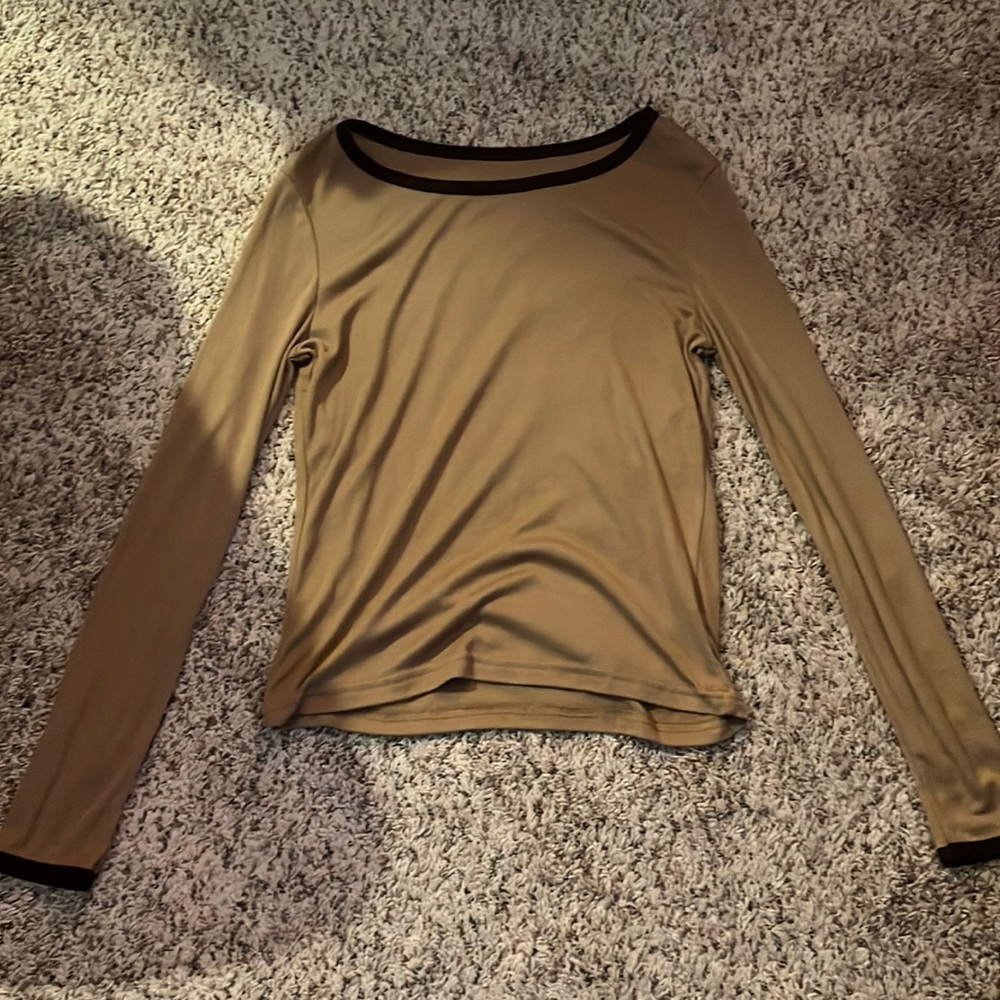 small, brown tee with a darker brown lining on the neck and the sleeves